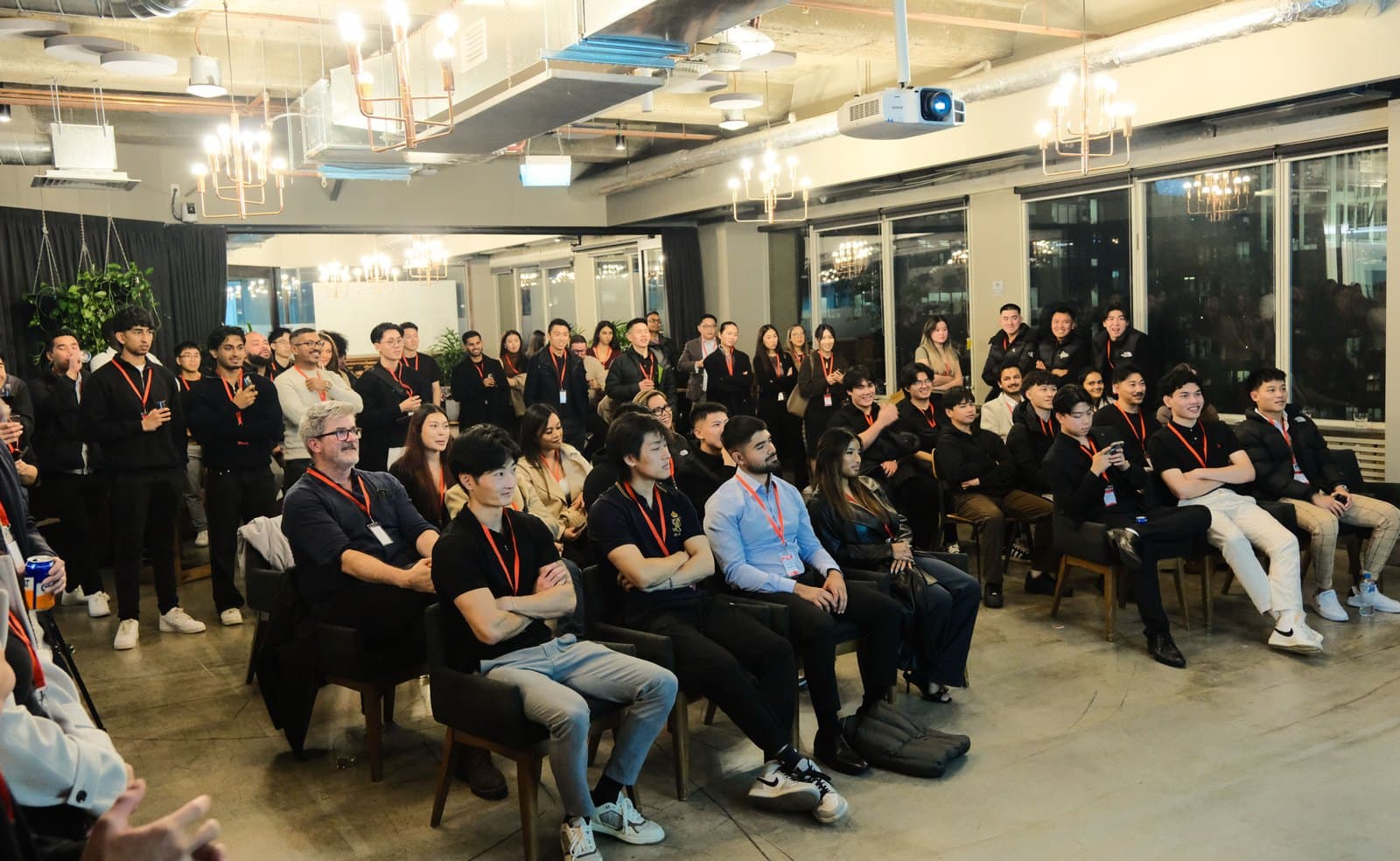 A full room of BNB Success Mentorship community members seated and standing at a live community event in Melbourne